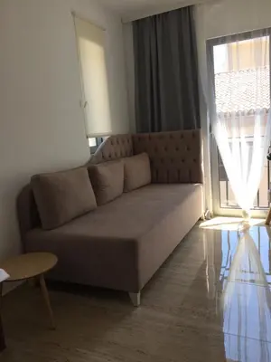 a couch in a living room with a window at Soheds in Budva