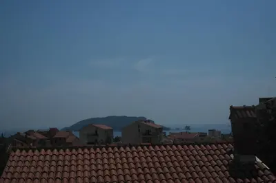 a view of a red roof with mountains in the background at Soheds in Budva