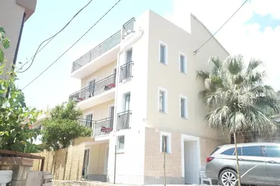 an apartment building with a car parked in front of it at Soheds in Budva