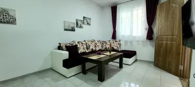 a living room with a couch and a table at Riviera Inn apartments in Ulcinj