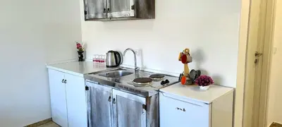 a small kitchen with a sink and a stove at Riviera Inn apartments in Ulcinj