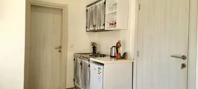 a kitchen with a stove and a white refrigerator at Riviera Inn apartments in Ulcinj