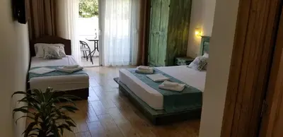 a hotel room with two beds and a table at Riviera Inn apartments in Ulcinj