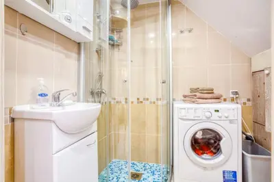a bathroom with a washing machine and a sink at Kotor Bagus - Cozy Boutique Old Town Studio with Seaview Terrace in Kotor