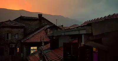 a group of buildings with mountains in the background at Kotor Bagus - Cozy Boutique Old Town Studio with Seaview Terrace in Kotor