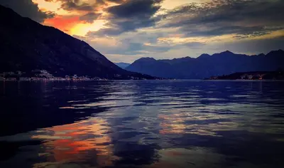 a view of a body of water at sunset at Kotor Bagus - Cozy Boutique Old Town Studio with Seaview Terrace in Kotor