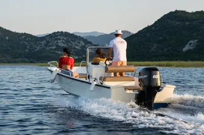 a group of people on a boat on the water at Wooden Village Resort in Ponari