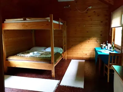 a room with two bunk beds in a cabin at Wooden Village Resort in Ponari