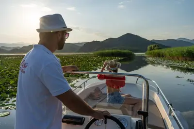 a man on a boat on a river at Wooden Village Resort in Ponari