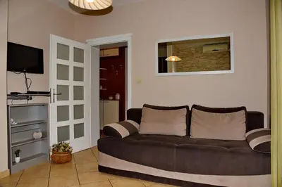 a living room with a couch and a television at Apartmani Ćetković in Kotor