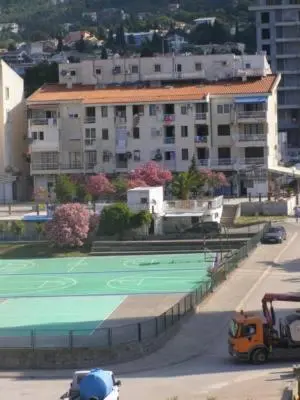 a tennis court in the middle of a city at Aleksandar in Sutomore