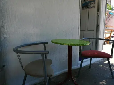 a table and two chairs and a green table and chairs at Aleksandar in Sutomore