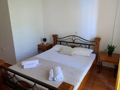a bedroom with a bed with two towels on it at Guesthouse Orlović in Budva