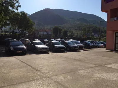 a row of cars parked in a parking lot at Guesthouse Orlović in Budva