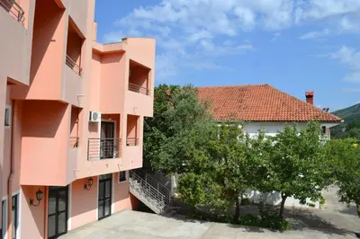 a view of two buildings and a tree at Guesthouse Orlović in Budva