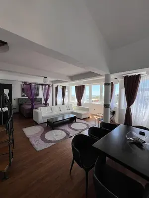 a living room with a couch and a table at Accommodation Royal Azur in Dobra Voda