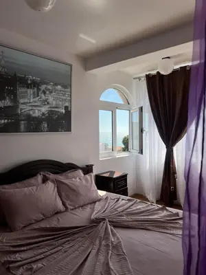 a bedroom with a large bed and a window at Accommodation Royal Azur in Dobra Voda