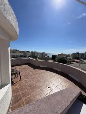 a patio with a table and a bench on a balcony at Accommodation Royal Azur in Dobra Voda