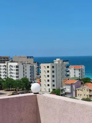 a view of a city with buildings and the ocean at Accommodation Royal Azur in Dobra Voda