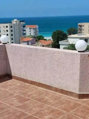a balcony with a view of the ocean and buildings at Accommodation Royal Azur in Dobra Voda