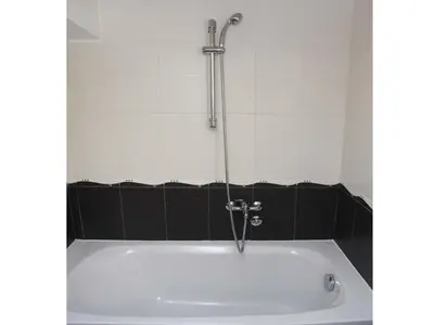 a bath tub with a faucet in a bathroom at Apartments Antonela in Sveti Stefan
