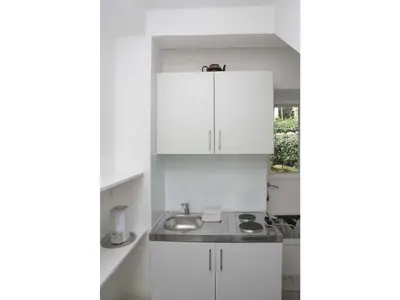 a kitchen with white cabinets and a sink at Apartments Antonela in Sveti Stefan
