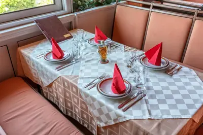 a table with red napkins on top of a table at Apartments Pod Lozom with Seaview in Petrovac na Moru
