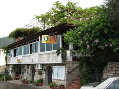a building with a sign on the side of it at Apartments Pod Lozom with Seaview in Petrovac na Moru