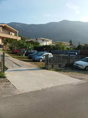 a bunch of cars parked in a parking lot at Apartmani Joca in Sutomore