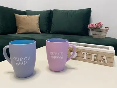 two coffee mugs sitting on a table in front of a couch at Villa Hanna in Ulcinj