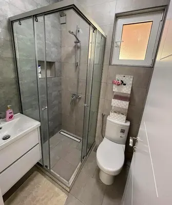 a bathroom with a shower and a toilet and a sink at Villa Hanna in Ulcinj