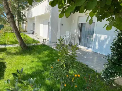 a house with a yard with grass and a patio at Villa Hanna in Ulcinj