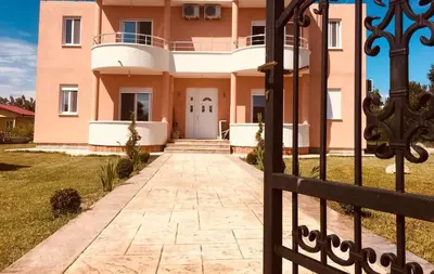 a villa with a gate in front of a house at S T A Apartmani in Ulcinj