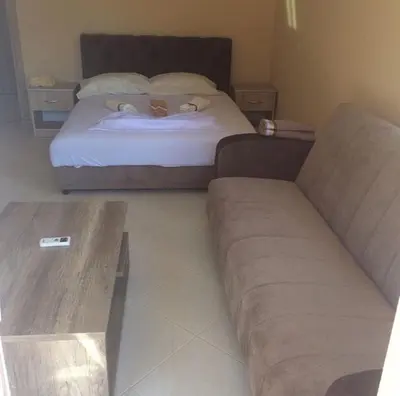 a living room with a bed and a couch at S T A Apartmani in Ulcinj