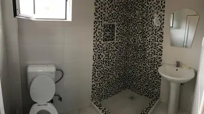 a bathroom with a toilet and a sink at S T A Apartmani in Ulcinj