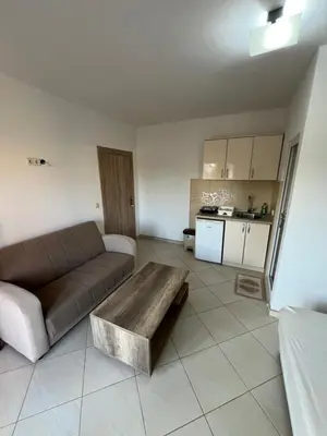 a living room with a couch and a coffee table at S T A Apartmani in Ulcinj