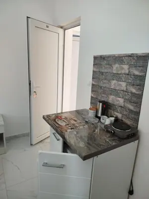 a kitchen with a counter top and a sink at Malina apartman in Utjeha
