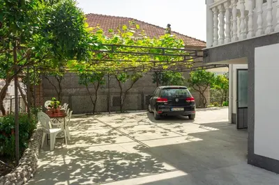 a car parked in the driveway of a house at Rooms Molabeciri in Ulcinj