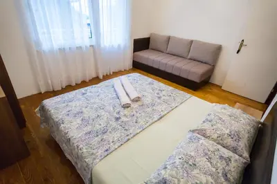 a living room with a bed and a couch at Rooms Molabeciri in Ulcinj