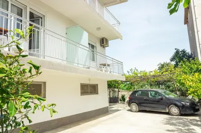 a car parked in the driveway of a house at Rooms Molabeciri in Ulcinj
