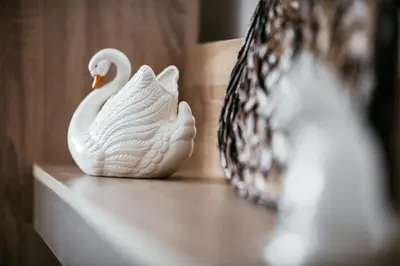 a white swan statue sitting on a counter at Big Hill Apartment in Kotor