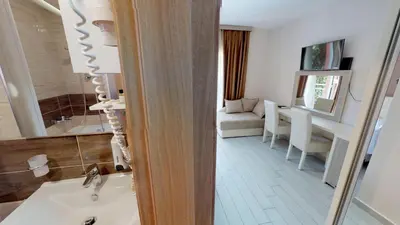 a bathroom with a sink and a living room at Villa Bojana in Budva