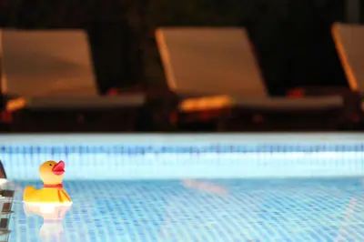 a toy rubber duck sitting on the edge of a pool at Villa Bojana in Budva