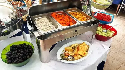 a table topped with a buffet of vegetables and food at Villa Bojana in Budva