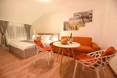 a bedroom with a bed and a table and chairs at Korzo apartmani in Podgorica