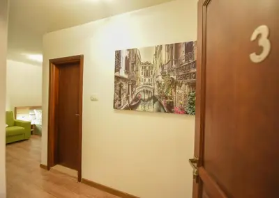 a hallway with a painting on the wall at Korzo apartmani in Podgorica