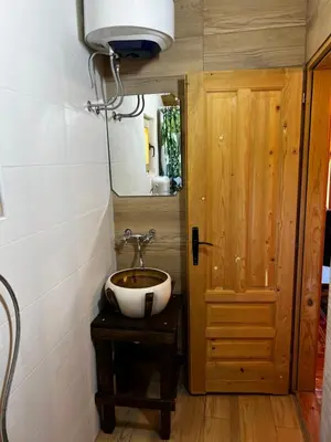 a bathroom with a sink and a mirror at Orahovo Cottages in Virpazar