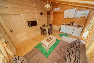 an overhead view of a living room and kitchen in a log cabin at Orahovo Cottages in Virpazar