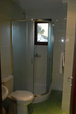 a bathroom with a shower with a toilet and a sink at Apartments Krapina in Budva