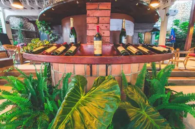 a barrel filled with bottles of wine and plants at Apartments Deus in Dobra Voda